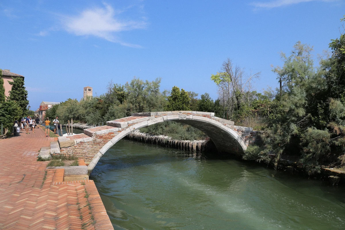 The stone Devil's Bridge on Torcello, the quiet stop included in the six-hour Murano Burano Torcello boat tour